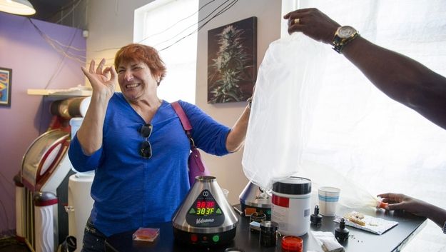 Mary Ann Blackwell (center) smokes marijuana out of a vaporizer during the East Bay Senior Social Club at the Magnolia Dispensary on Friday, Aug. 18, 2017, in Oakland, Calif. SOURCE: Santiago Mejia