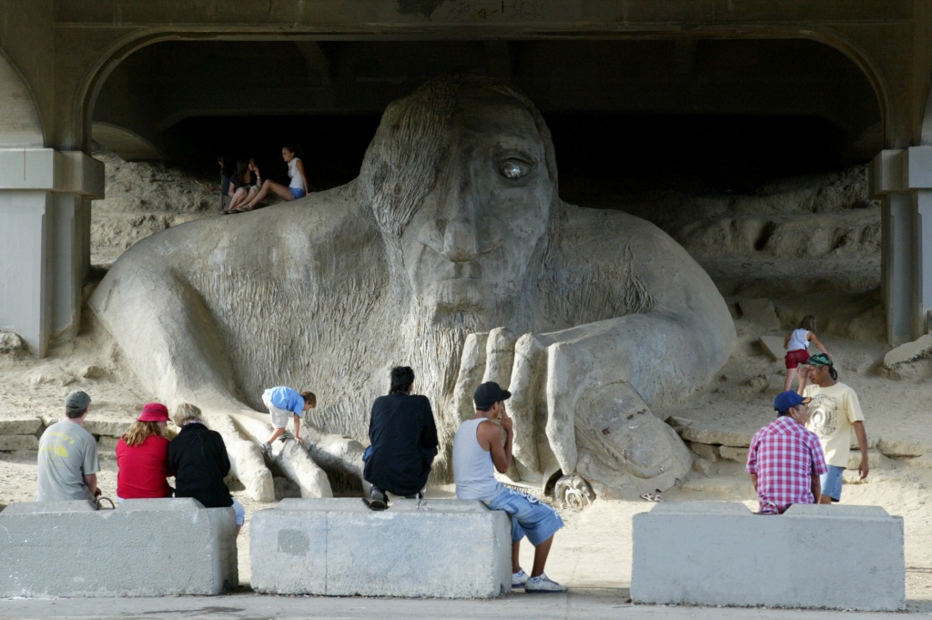 Visitors check out the Fremont Troll under the Aurora Bridge in Fremont on Friday July 6, 2007. Photo by Joshua Trujillo / Seattle Post-Intelligencer