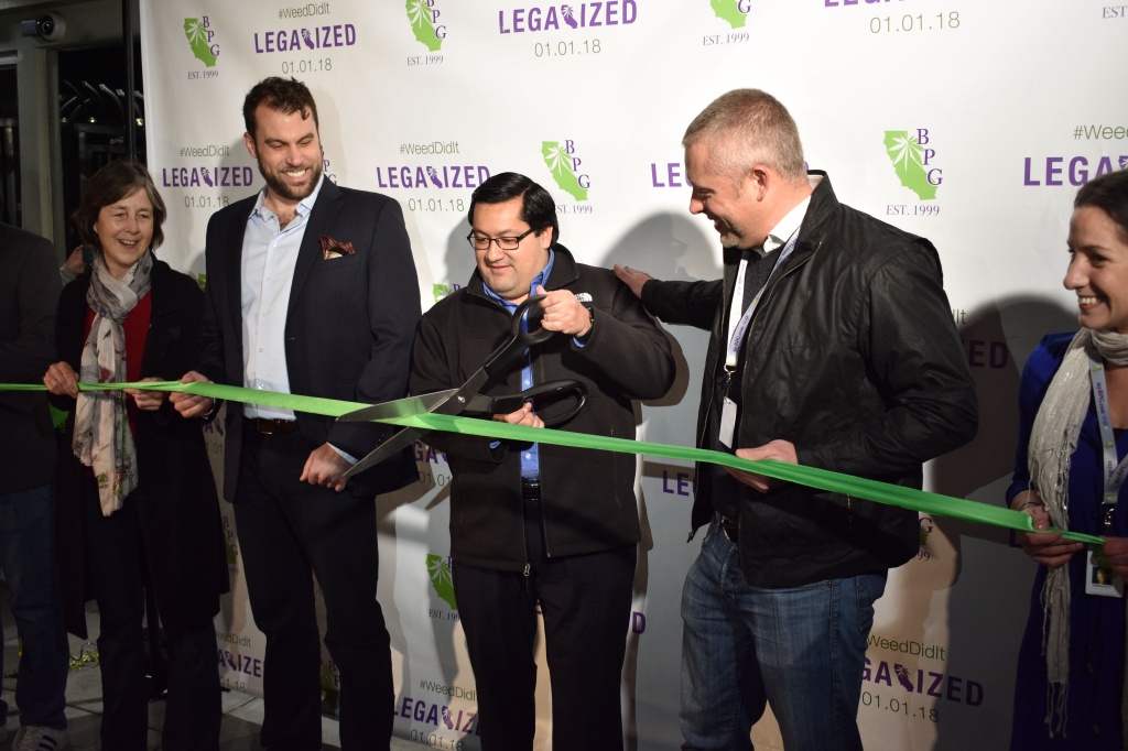 Berkeley Mayor Jesse Arreguin cuts the ribbon on Berkeley Patients Group's legal sales of recreational marijuana at 6 am on Jan. 1.