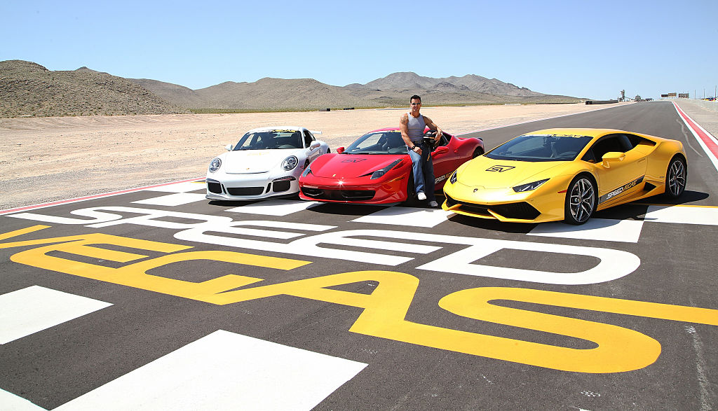 Actor/model Antonio Sabato Jr. poses with a 2015 Porsche 911 GT3, a 2013 Ferrari 458 Italia and a 2015 Lamborghini Huracan at the SpeedVegas motorsports complex on May 30, 2016 in Las Vegas. | Photo: Getty